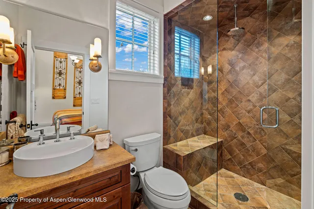 a bathroom with a toilet sink and shower