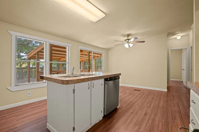 a kitchen with a sink and wooden floor