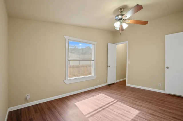 wooden floor in an empty room with a window