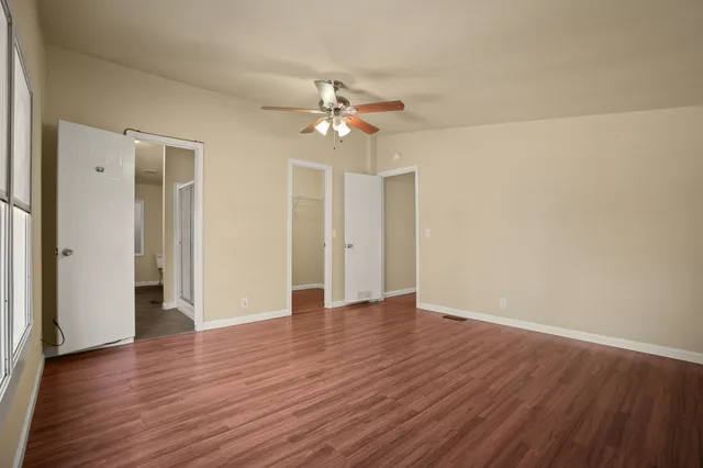a view of an empty room with wooden floor