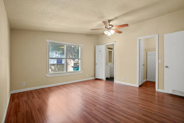 wooden floor in an empty room with a window