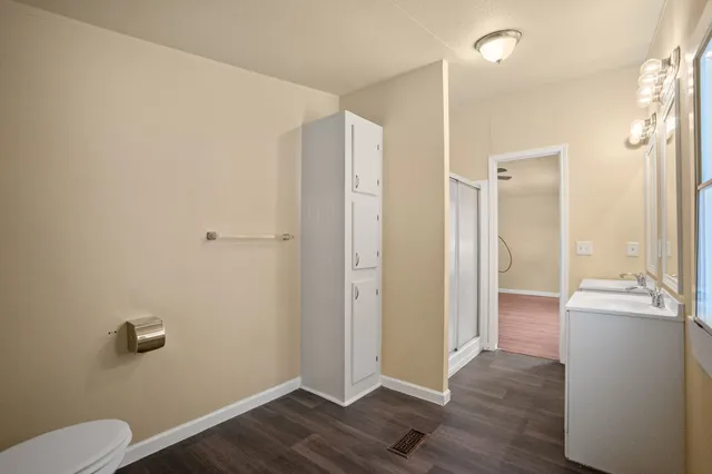 a view of a bathroom with a hardwood floor and a sink