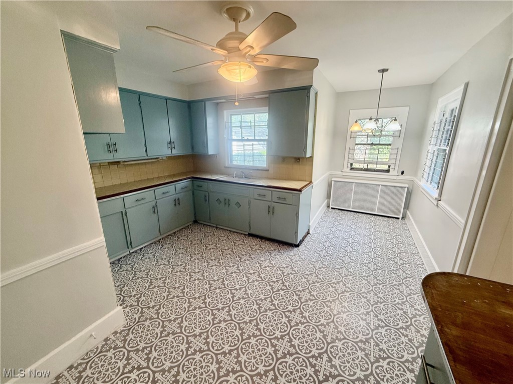 1979 Staunton Road Cleveland, OH 44118 - Photo 8 of 37 Kitchen featuring decorative light fixtures, tasteful backsplash, and a ceiling fan
