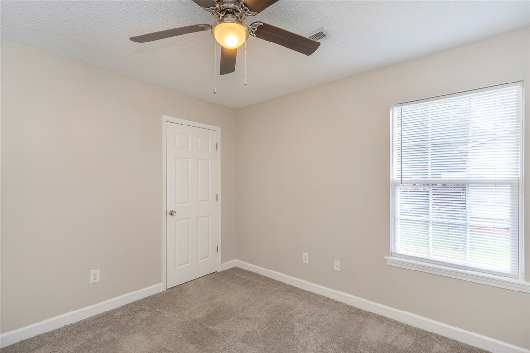 2509 Rolling Green Road Anderson, SC 29621 - Photo 22 of 28 Comfortable bedroom with plush carpet and a convenient ceiling fan for optimal airflow.