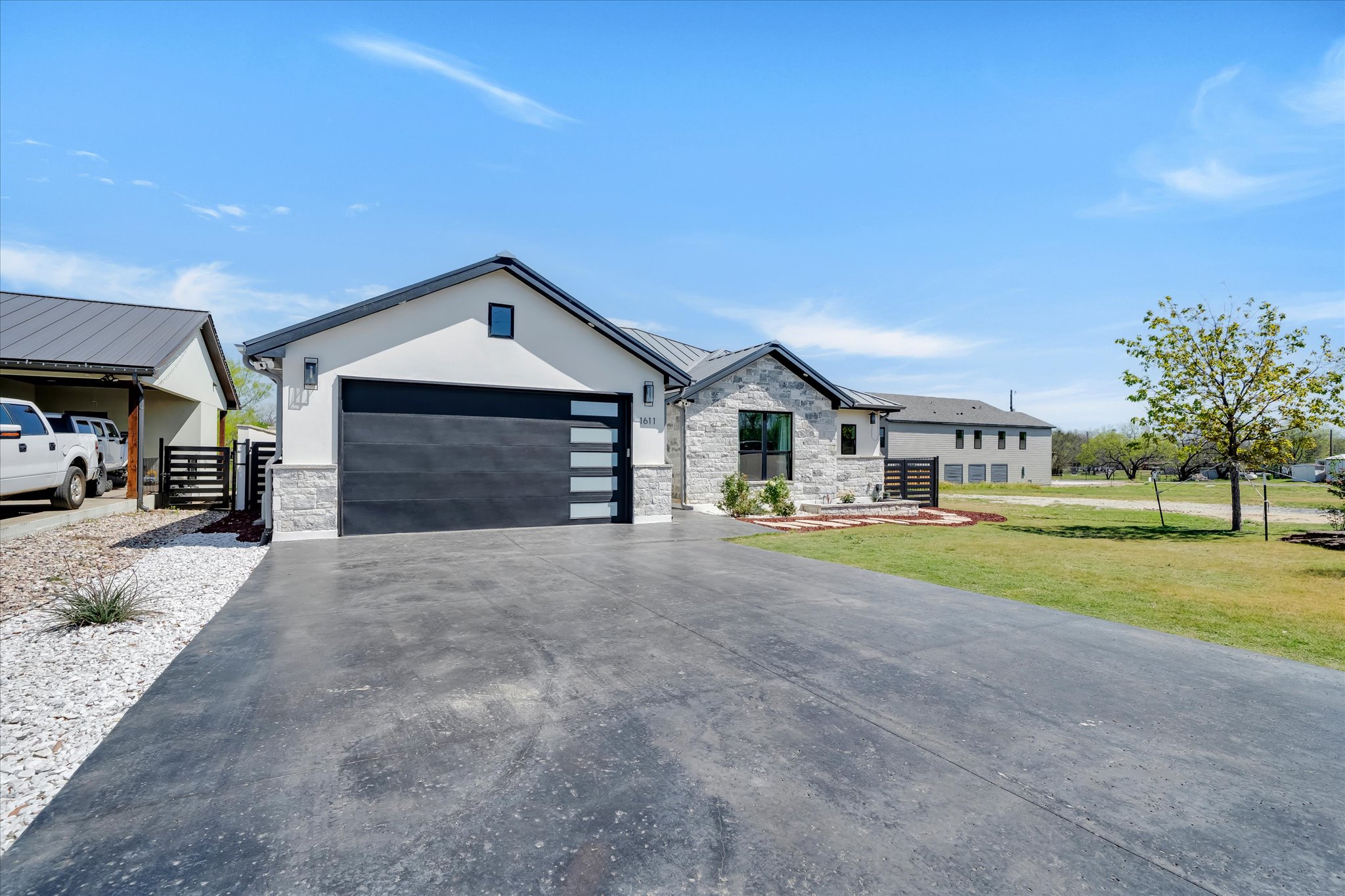 a front view of a house with a yard and garage