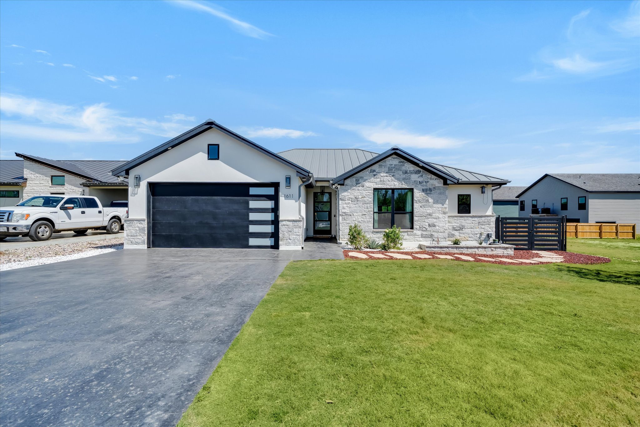 1611 Johnson Street Marble Falls, TX 78654 - Photo 2 of 40 a front view of a house with a garden and porch