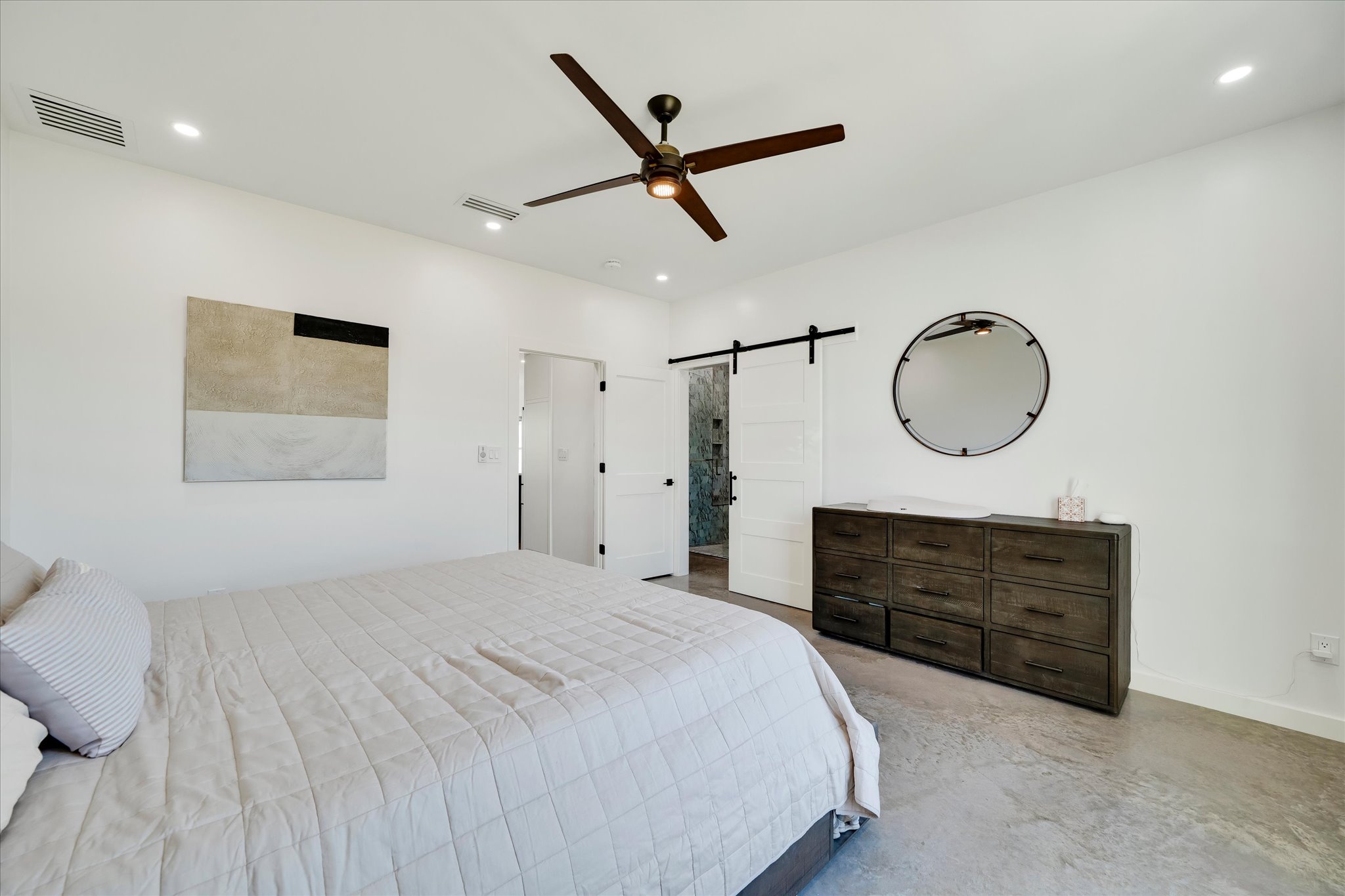 1611 Johnson Street Marble Falls, TX 78654 - Photo 22 of 40 a bedroom with a bed a dresser and window