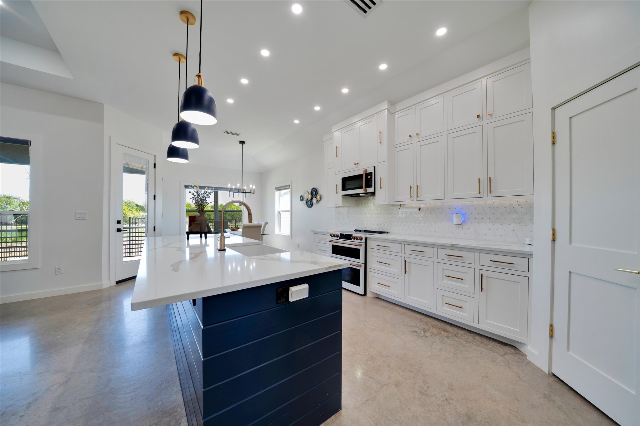 1611 Johnson Street Marble Falls, TX 78654 - Photo 10 of 40 a kitchen with white cabinets and appliances