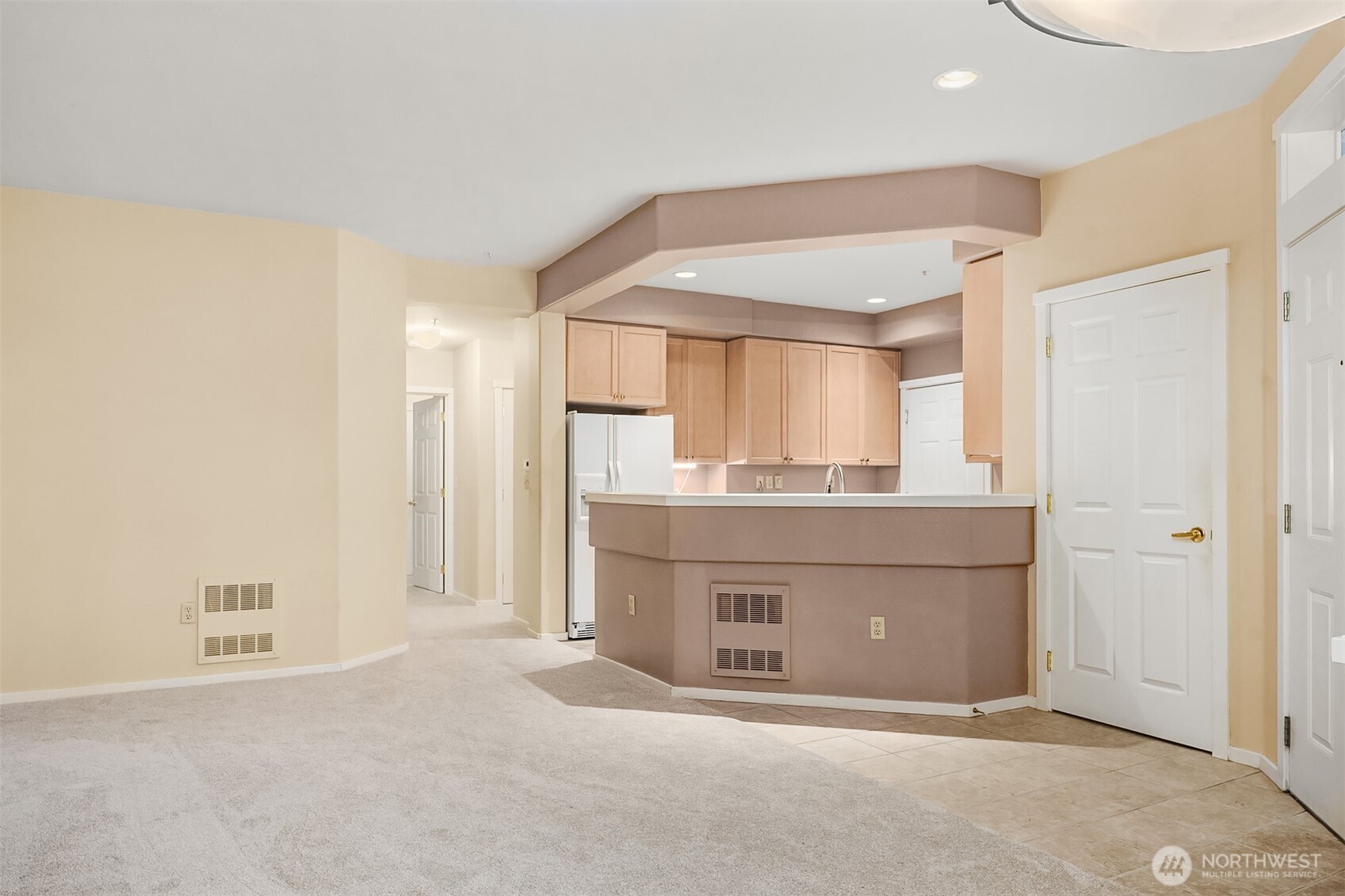 4325 Northeast 5th Court, Unit C101 Renton, WA 98059 - Photo 6 of 17 a room with kitchen island a sink and a refrigerator