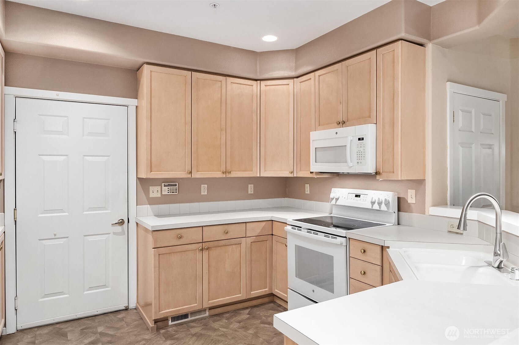 4325 Northeast 5th Court, Unit C101 Renton, WA 98059 - Photo 8 of 17 a kitchen with a sink cabinets and appliances