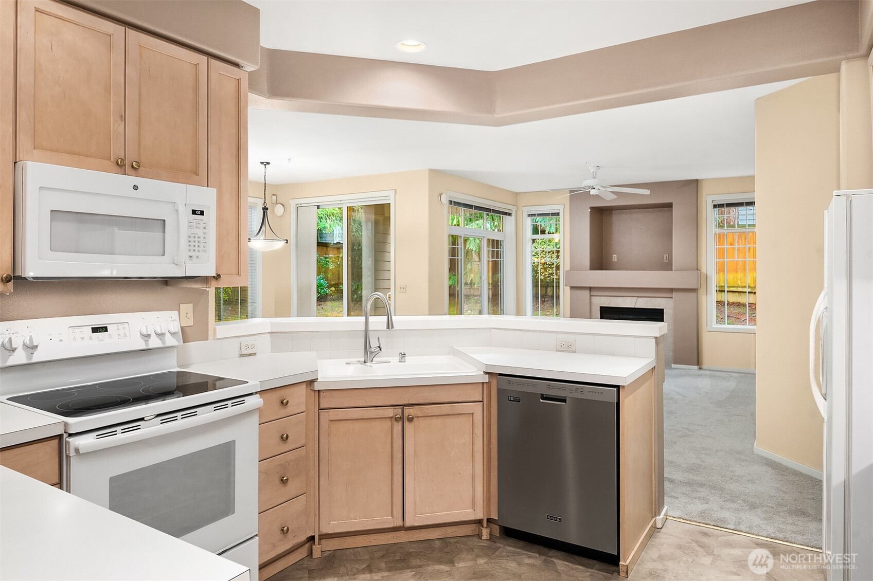 4325 Northeast 5th Court, Unit C101 Renton, WA 98059 - Photo 9 of 17 a kitchen with a sink stove and cabinets
