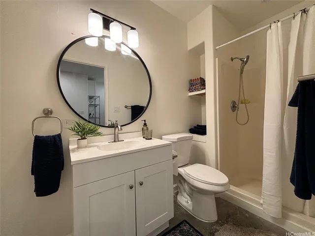 a bedroom with a bed and a night stand