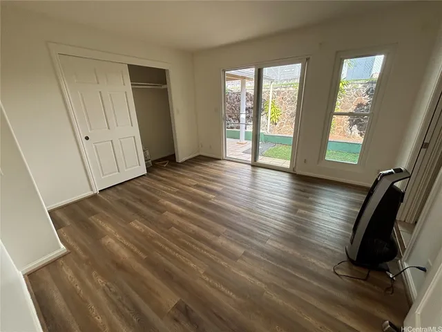a view of a room with wooden floor and windows