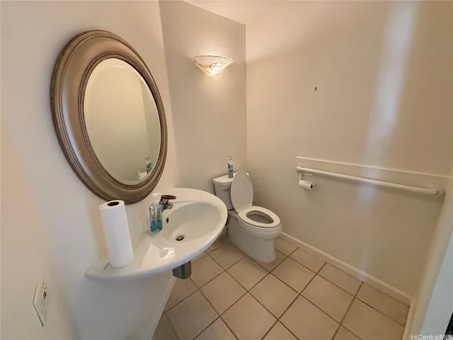 a bathroom with a toilet and a mirror