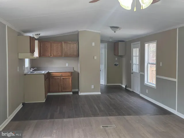 a view of a kitchen with a sink dishwasher oven and cabinets