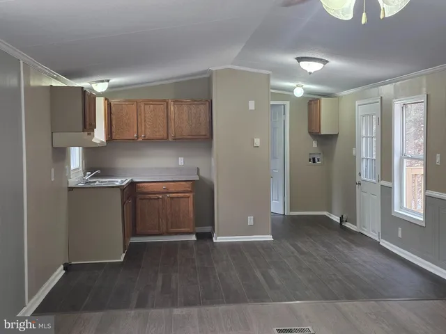 a kitchen with a refrigerator and a stove top oven