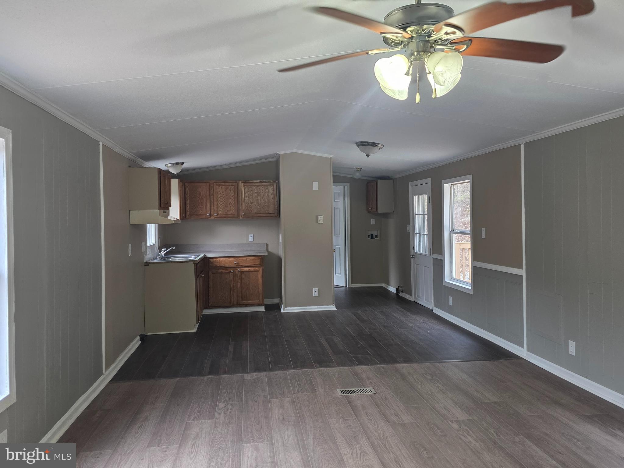 2732 Crossroad School Road Hedgesville, WV 25427 - Photo 28 of 41 a kitchen with stainless steel appliances granite countertop a refrigerator a sink dishwasher a stove and white countertops with wooden floor
