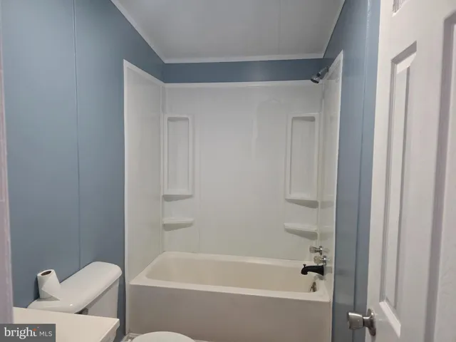 a bathroom with a bathtub and toilet