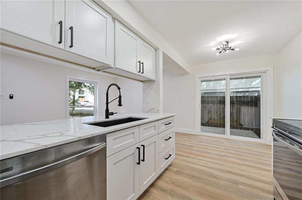 3511 Alpine Circle, Unit 1 Austin, TX 78704 - Photo 11 of 22 a kitchen with granite countertop white cabinets and white appliances