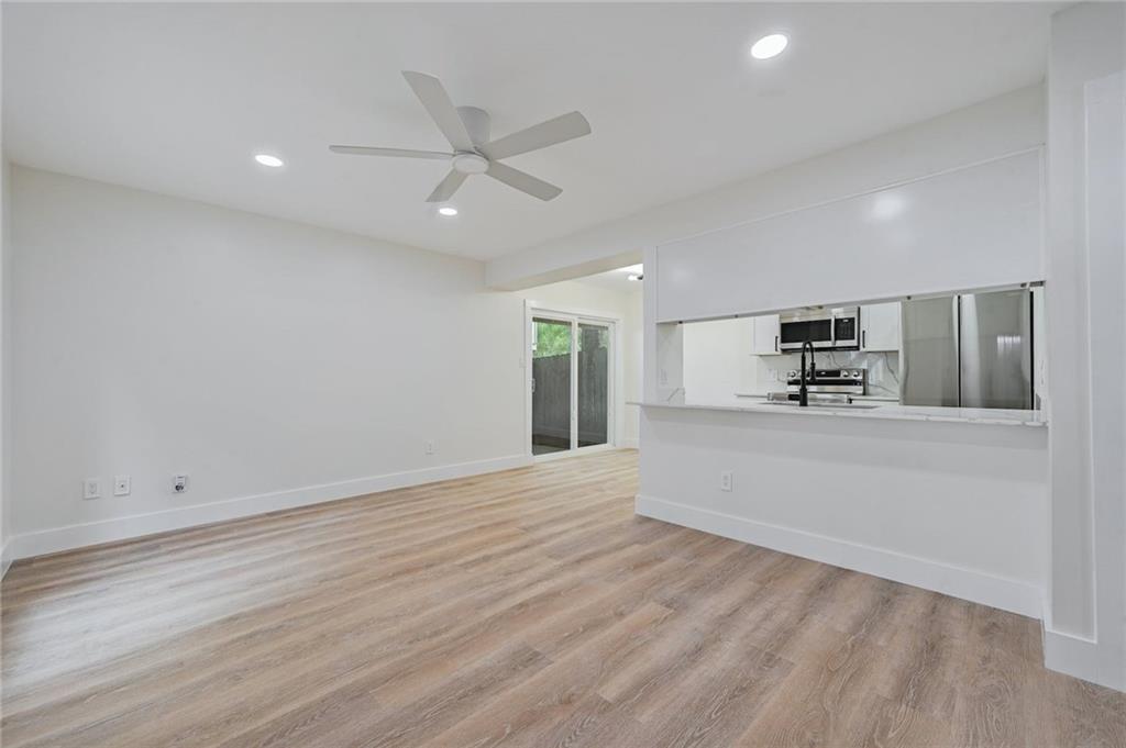 3511 Alpine Circle, Unit 1 Austin, TX 78704 - Photo 4 of 22 an empty room with wooden floor cabinet and windows