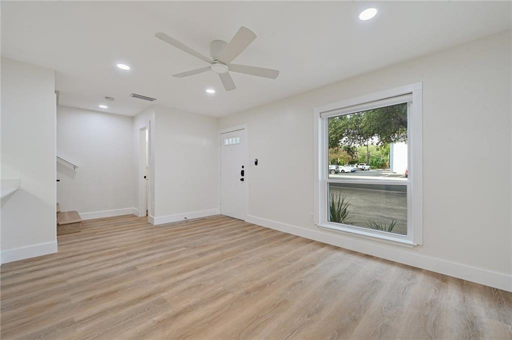 3511 Alpine Circle, Unit 1 Austin, TX 78704 - Photo 6 of 22 an empty room with wooden floor a ceiling fan and windows