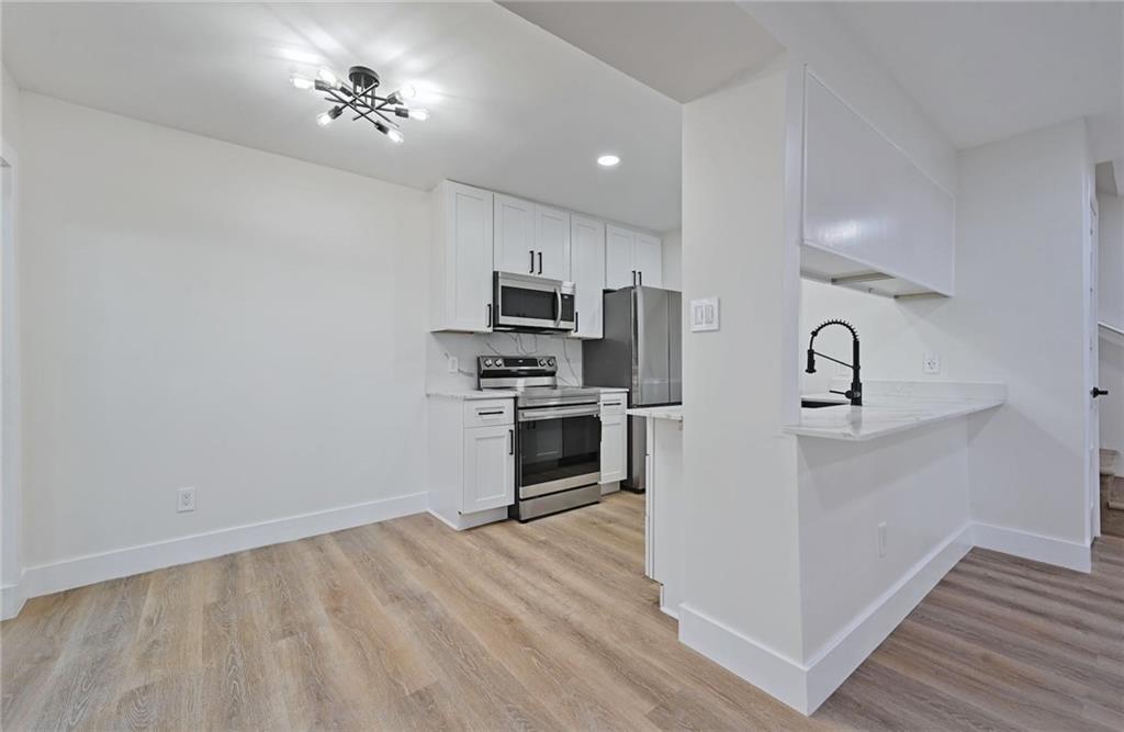 3511 Alpine Circle, Unit 1 Austin, TX 78704 - Photo 7 of 22 a kitchen with a refrigerator cabinets and wooden floor