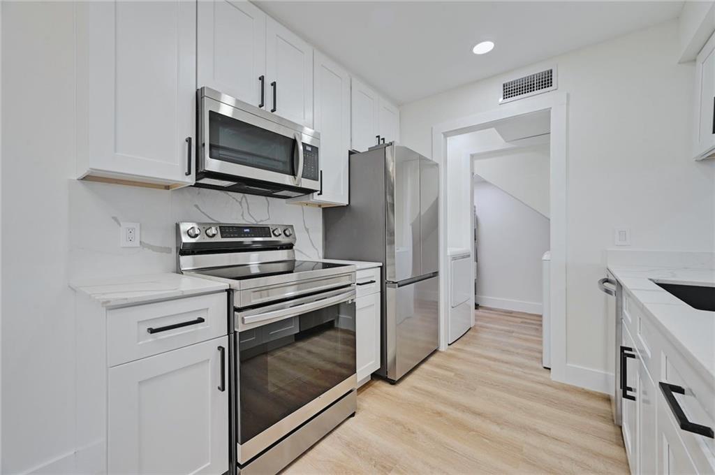3511 Alpine Circle, Unit 1 Austin, TX 78704 - Photo 8 of 22 a kitchen with stainless steel appliances a stove a microwave and a refrigerator
