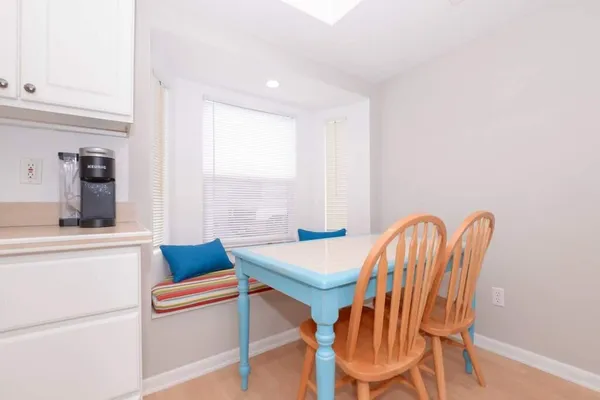 a kitchen that has a lot of cabinets in it and wooden floors