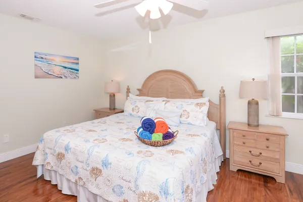 a bedroom with bed and wooden floor