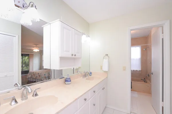 a bathroom with double sink and a mirror