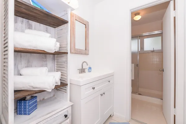 a bathroom with a sink vanity and a mirror