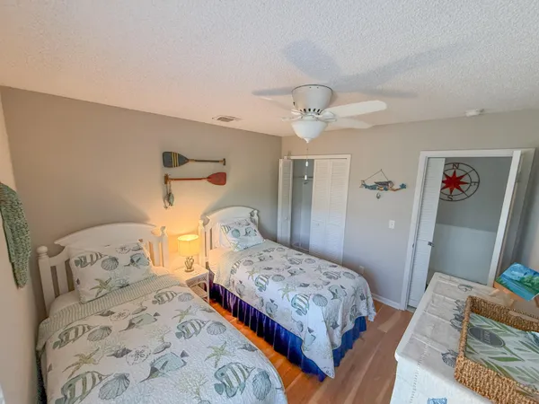 a bedroom with bed and wooden floor