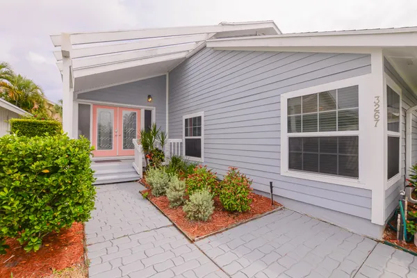 a front view of a house with a garden