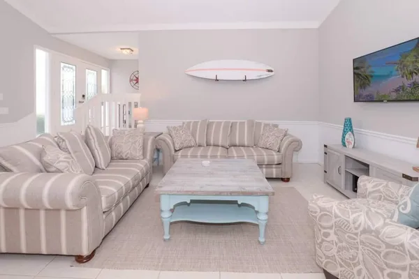 a living room with furniture and a chandelier