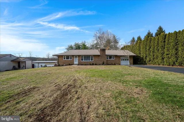 a front view of house with yard and seating area