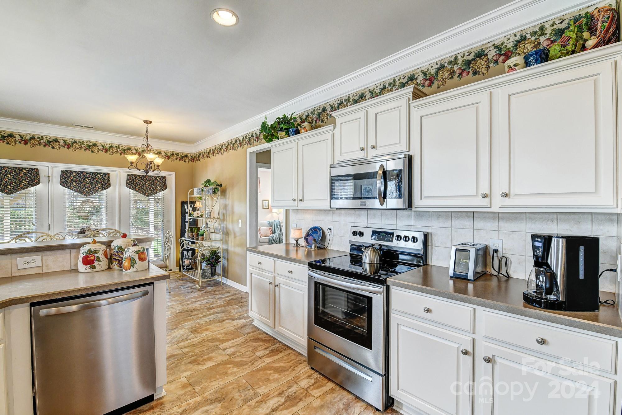 182 Harris Farm Road Mooresville, NC 28115 - Photo 12 of 46 a kitchen with stainless steel appliances a sink stove and cabinets