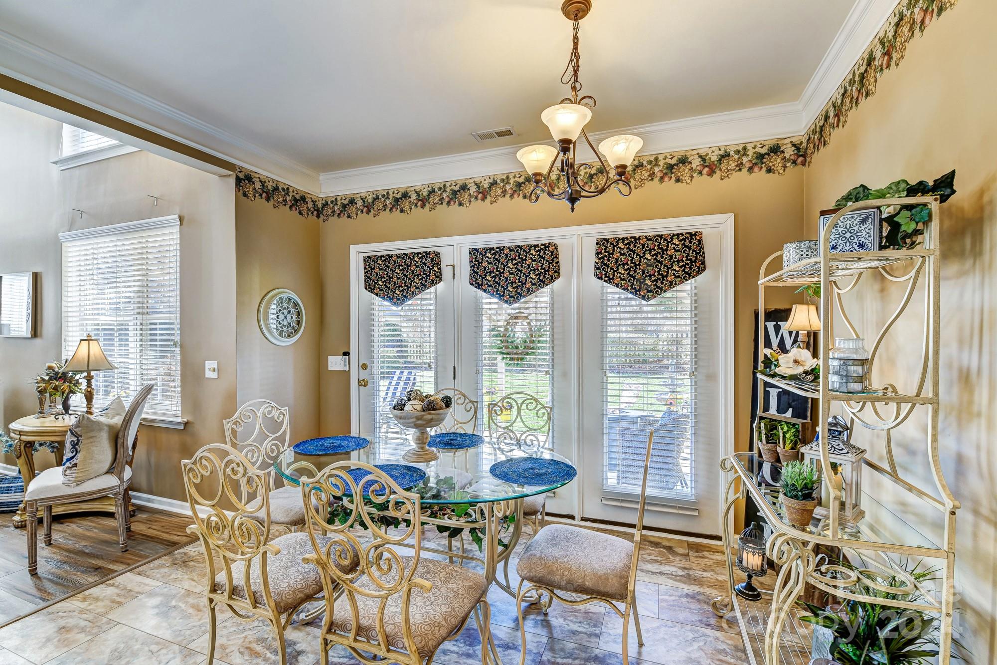 182 Harris Farm Road Mooresville, NC 28115 - Photo 13 of 46 a view of a dining room with furniture wooden floor and chandelier