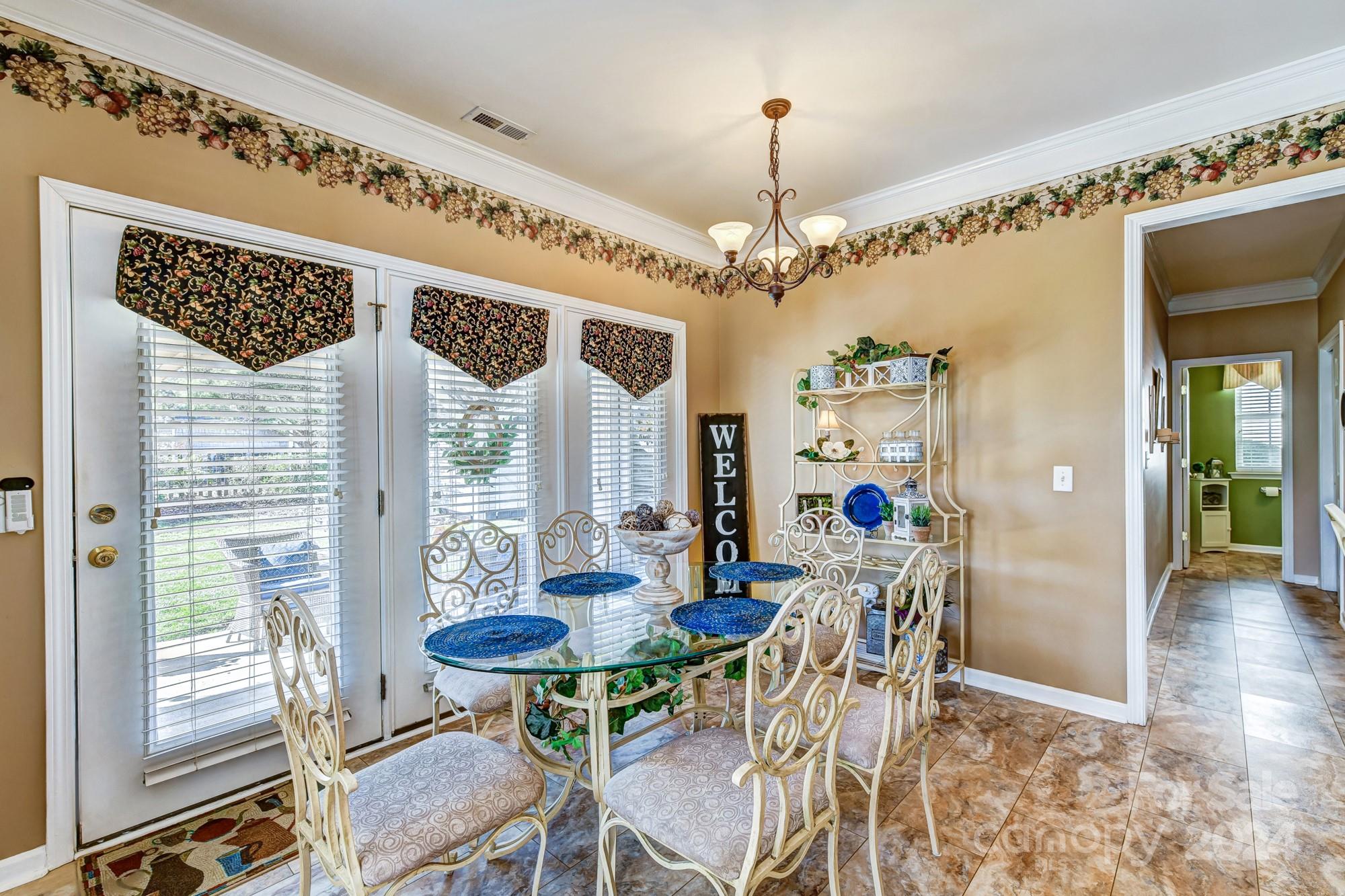 182 Harris Farm Road Mooresville, NC 28115 - Photo 14 of 46 a view of a dining room with furniture and wooden floor