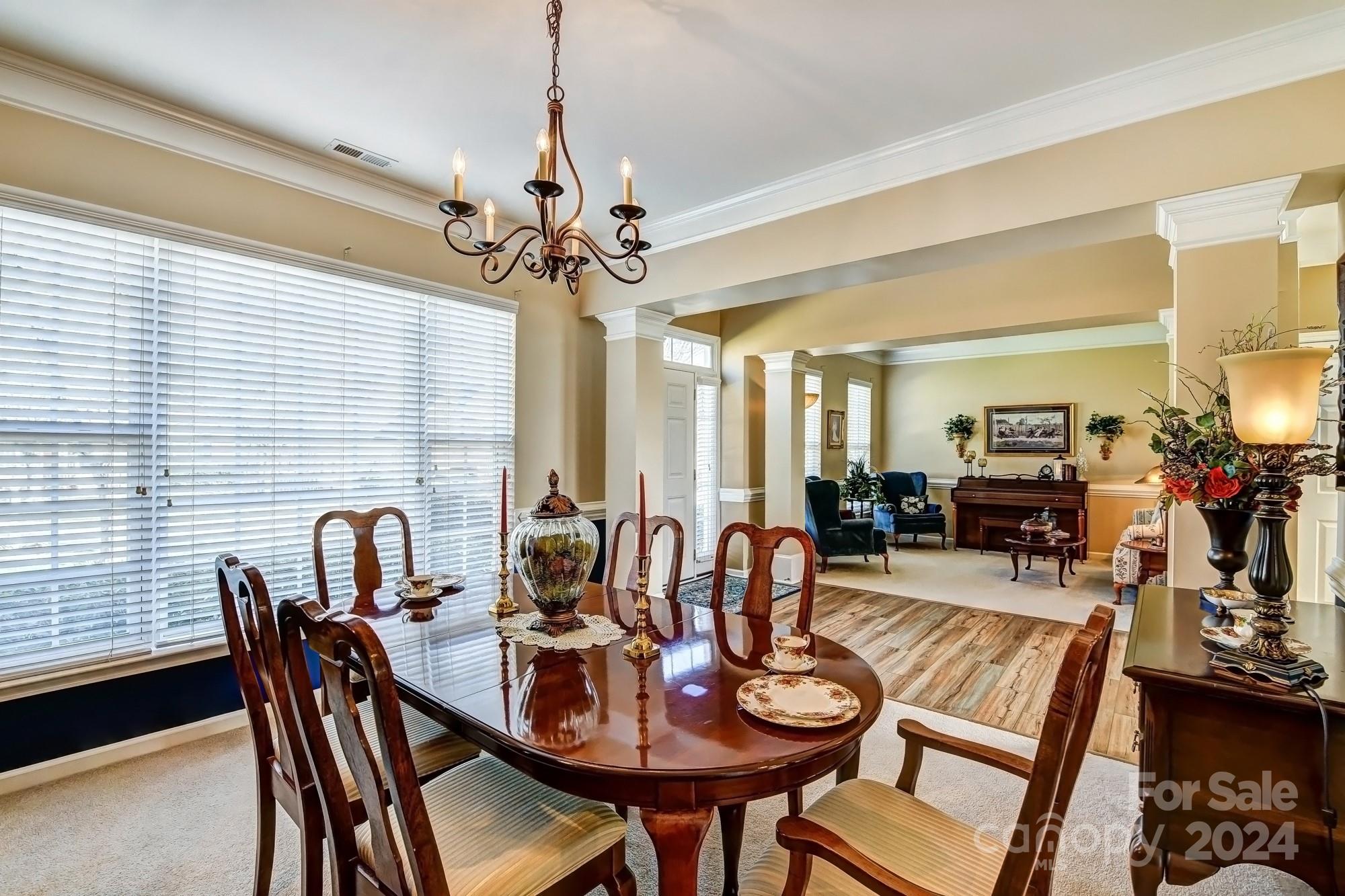 182 Harris Farm Road Mooresville, NC 28115 - Photo 16 of 46 a view of a dining room with furniture window and wooden floor
