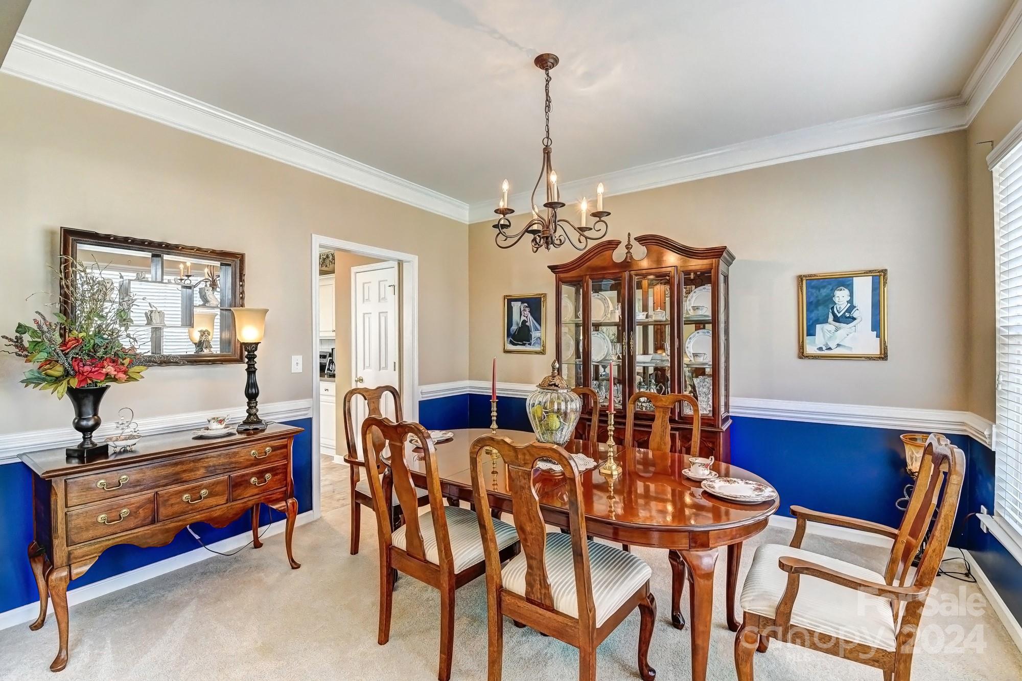 182 Harris Farm Road Mooresville, NC 28115 - Photo 17 of 46 a view of a dining room with furniture and chandelier