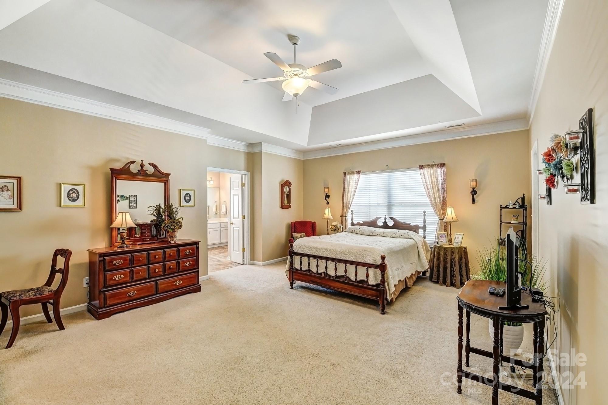 182 Harris Farm Road Mooresville, NC 28115 - Photo 27 of 46 a spacious bedroom with a bed and a chandelier