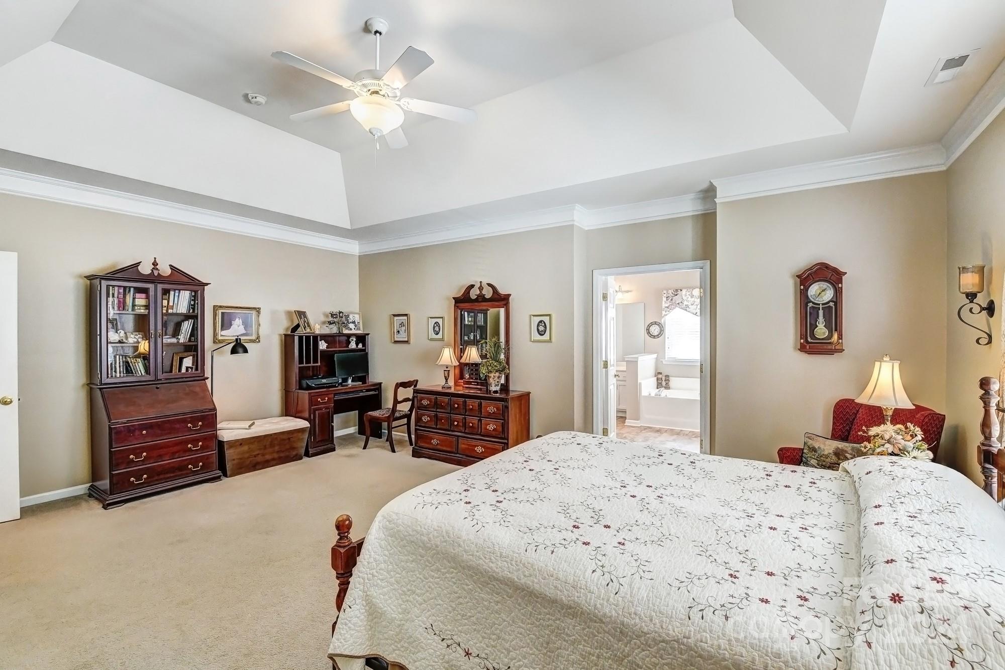 182 Harris Farm Road Mooresville, NC 28115 - Photo 28 of 46 a bedroom with a bed dresser and a chandelier
