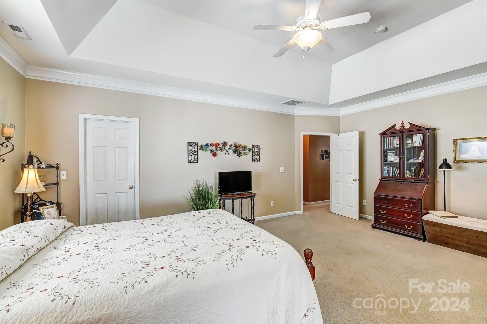 182 Harris Farm Road Mooresville, NC 28115 - Photo 29 of 46 a bedroom with a bed and a chandelier