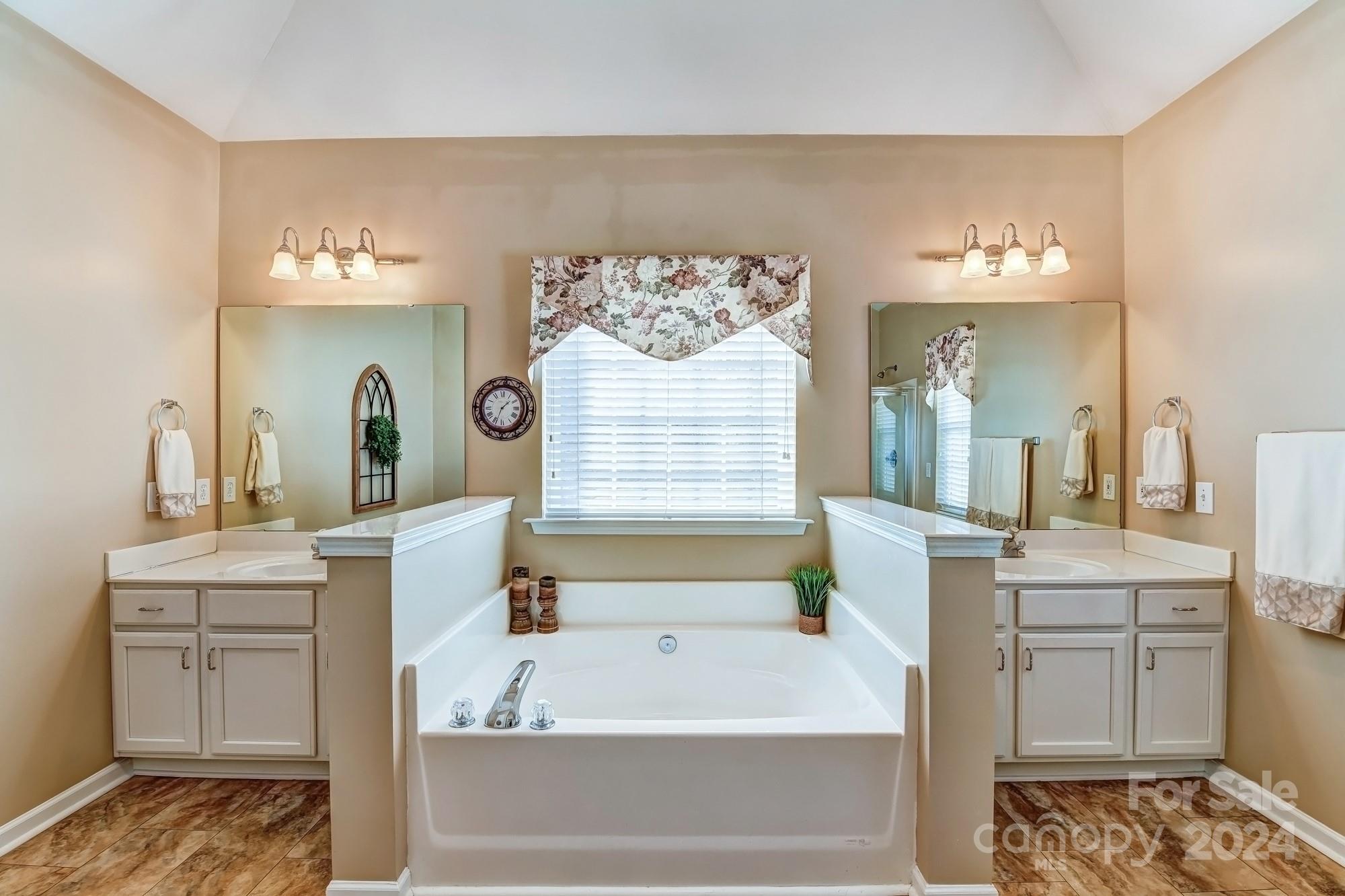 182 Harris Farm Road Mooresville, NC 28115 - Photo 30 of 46 a bathroom with a bathtub sink and mirror