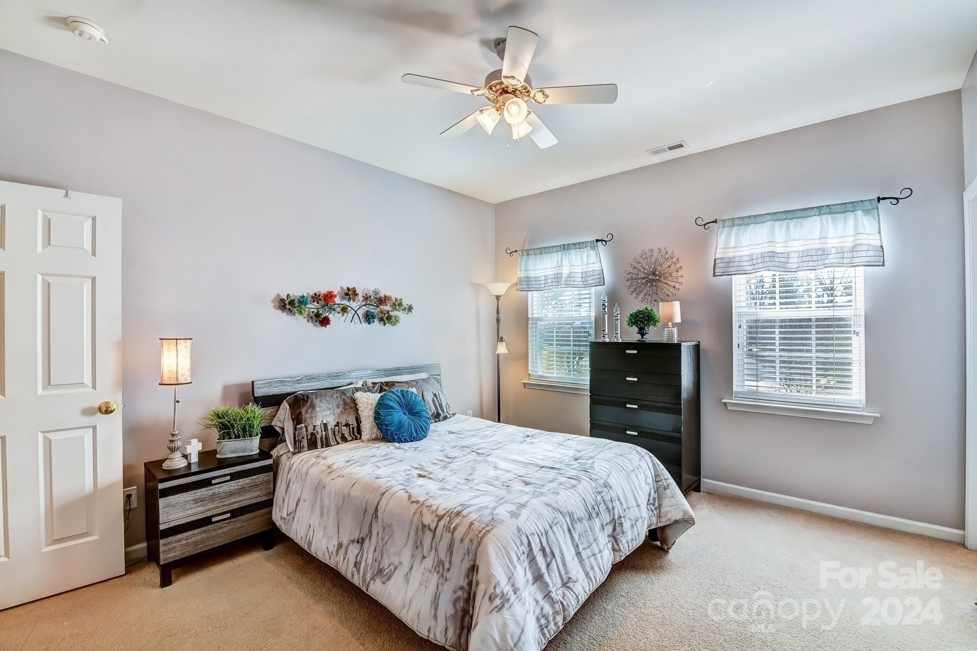 182 Harris Farm Road Mooresville, NC 28115 - Photo 32 of 46 a bedroom with a large bed and a chandelier