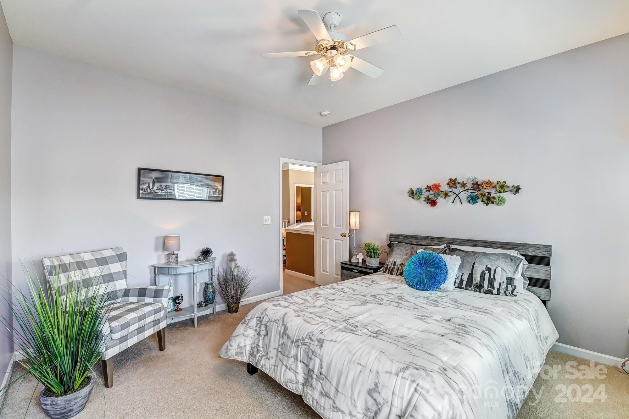 182 Harris Farm Road Mooresville, NC 28115 - Photo 33 of 46 a bedroom with a bed and a chandelier