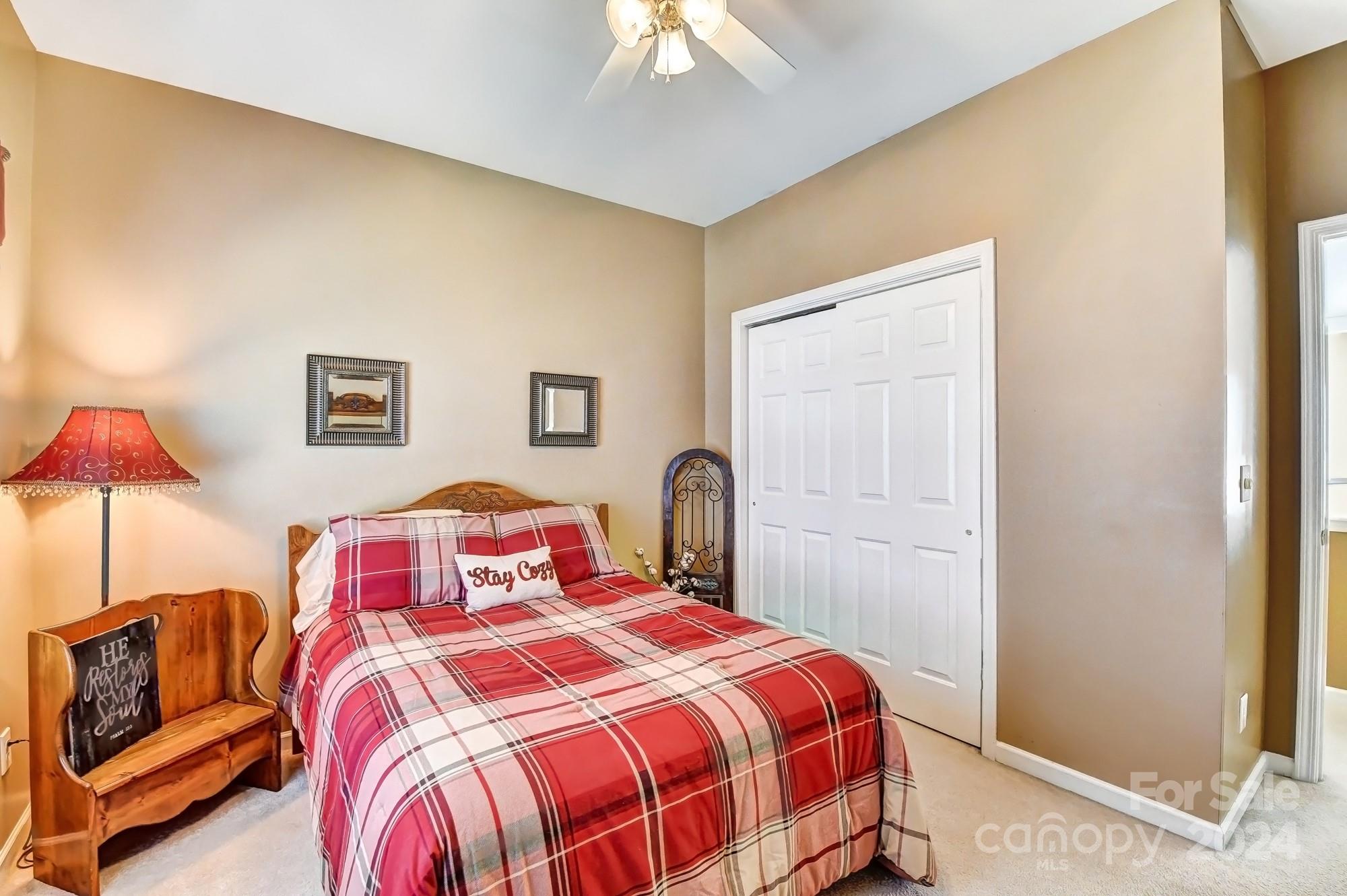 182 Harris Farm Road Mooresville, NC 28115 - Photo 37 of 46 a bedroom with a bed and a chandelier