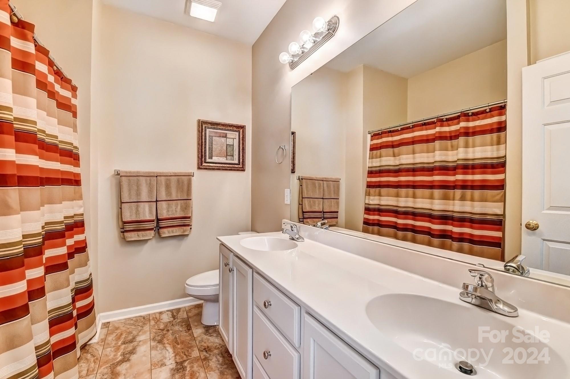 182 Harris Farm Road Mooresville, NC 28115 - Photo 40 of 46 a bathroom with a sink a toilet and shower curtain