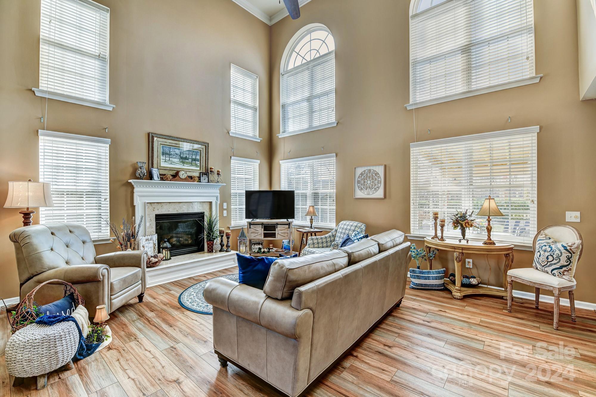 182 Harris Farm Road Mooresville, NC 28115 - Photo 4 of 46 a living room with furniture a fireplace and a large window