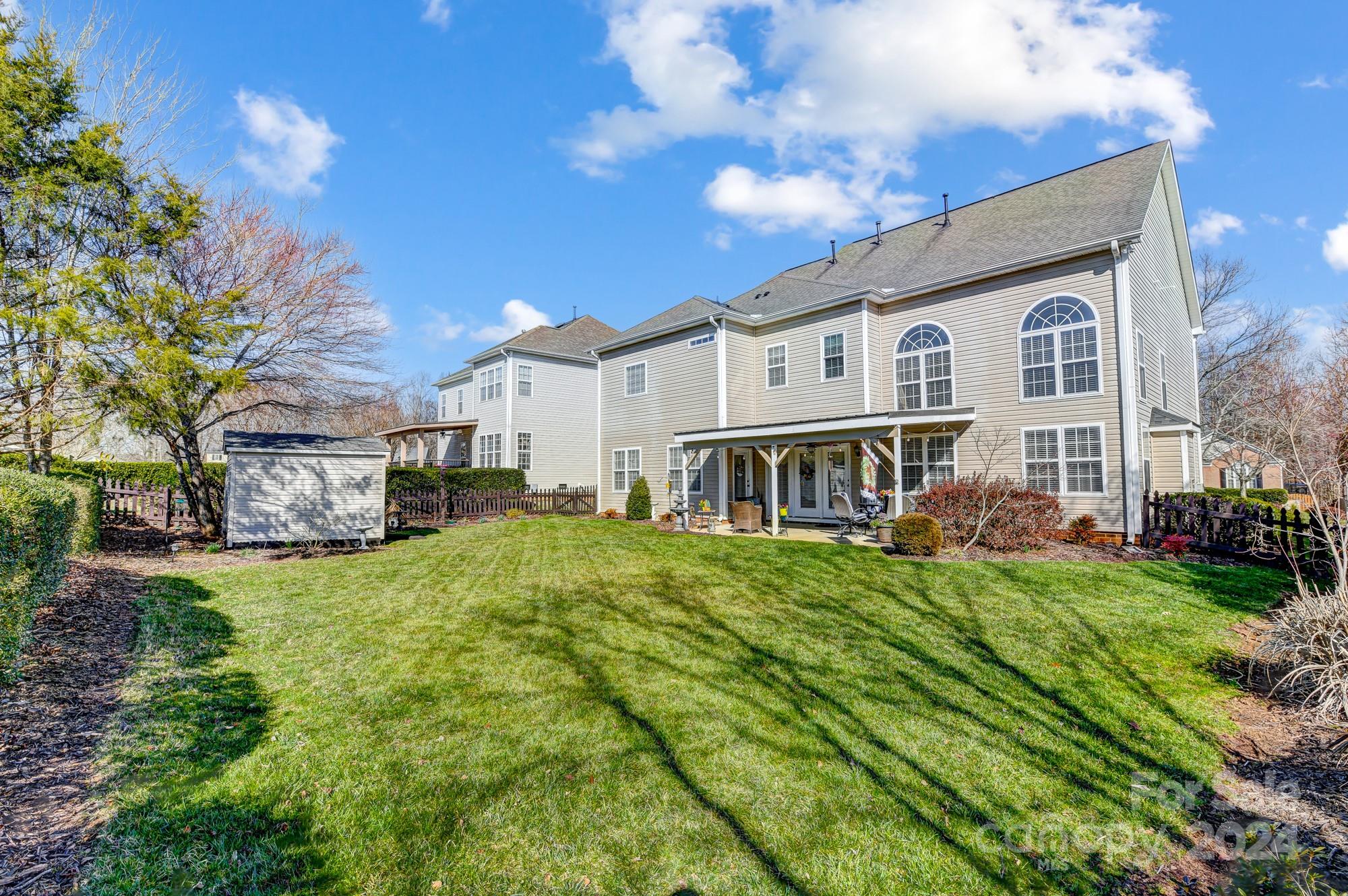 182 Harris Farm Road Mooresville, NC 28115 - Photo 45 of 46 a view of a big house with a big yard plants and large trees
